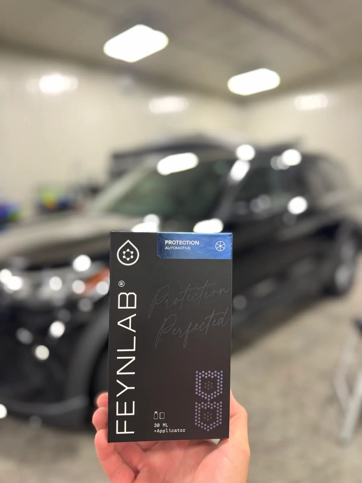 FEYNLAB automotive protection package held in front of a vehicle