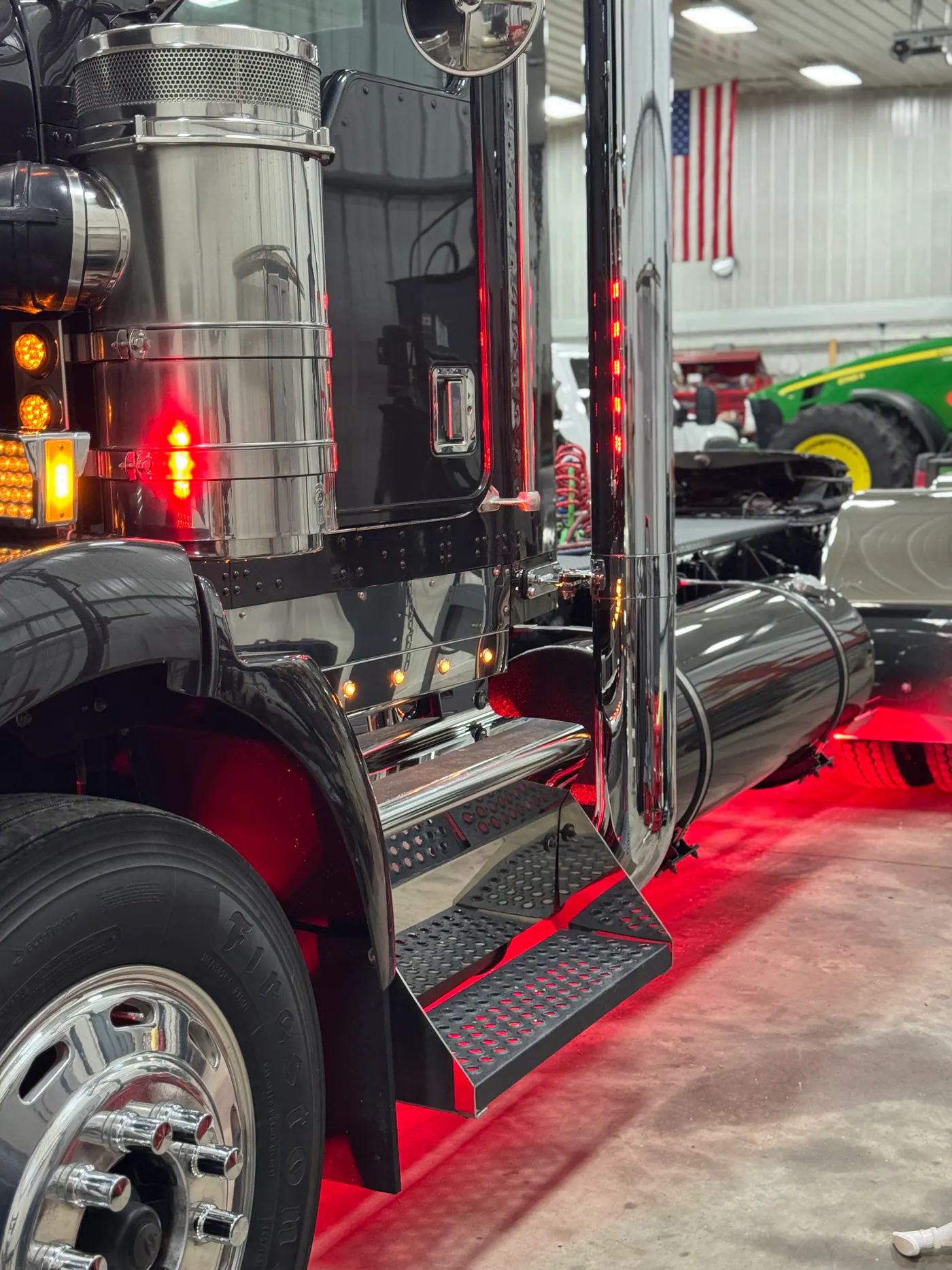 Black semi truck side with polished chrome and red lighting