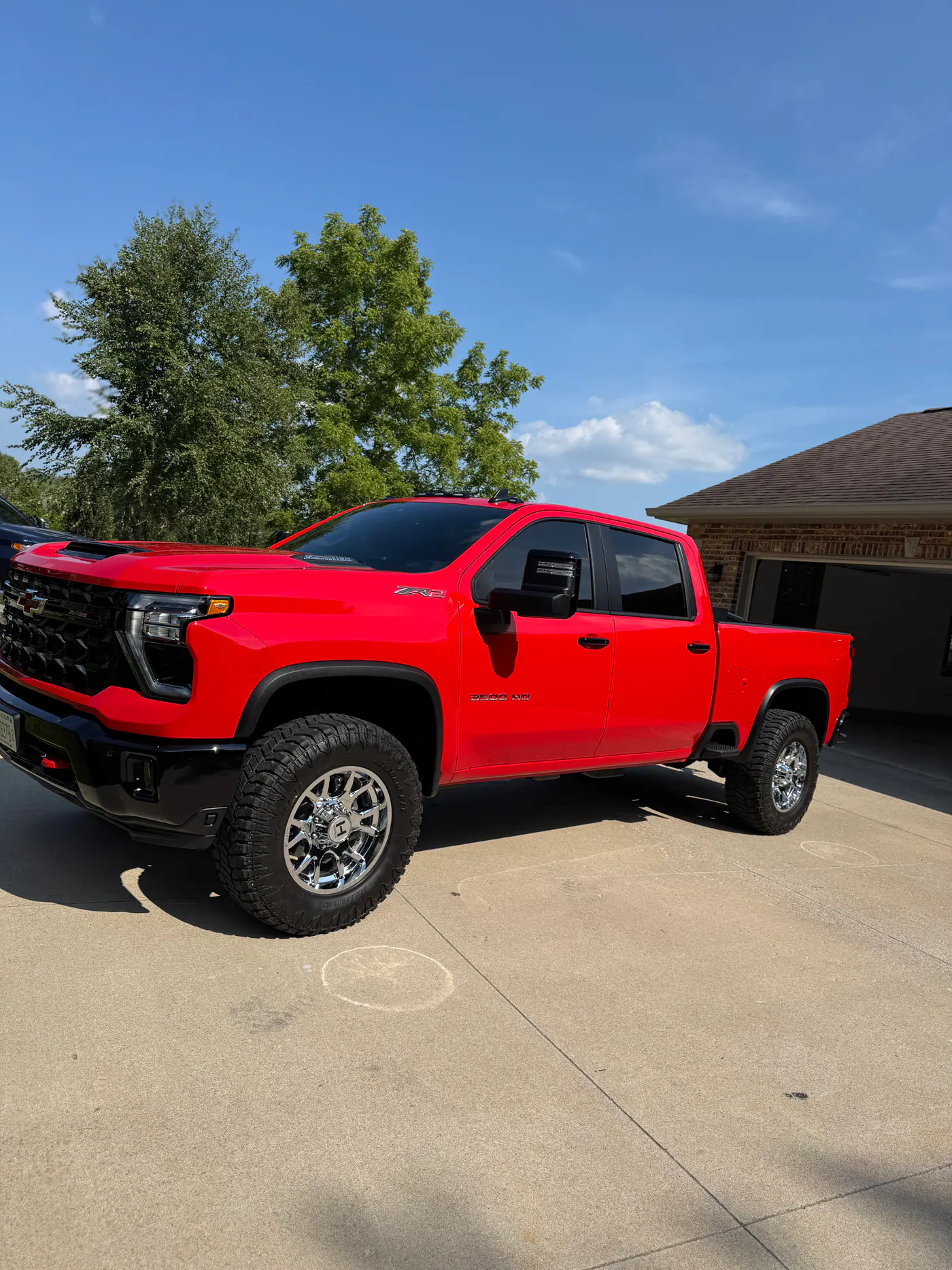 Red Chevrolet heavy-duty pickup parked on a driveway