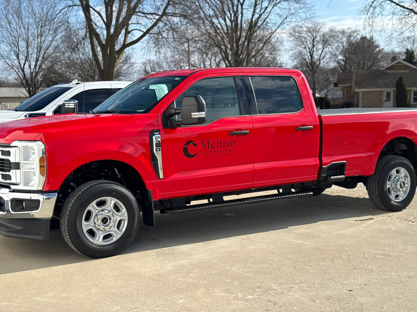 Red Ford work truck with Melton Seed and Service door lettering