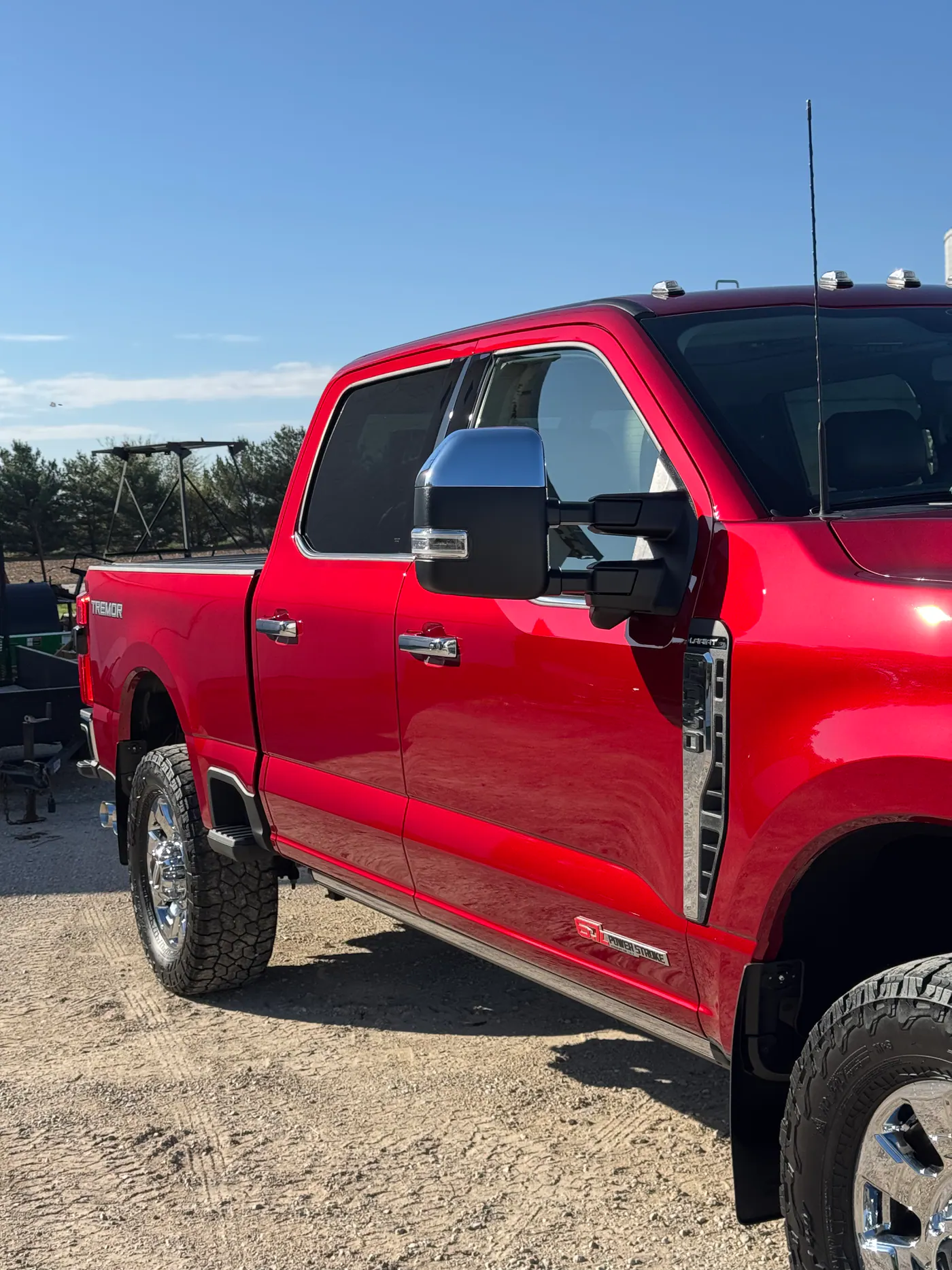Red Ford Super Duty pickup photographed in bright sunlight