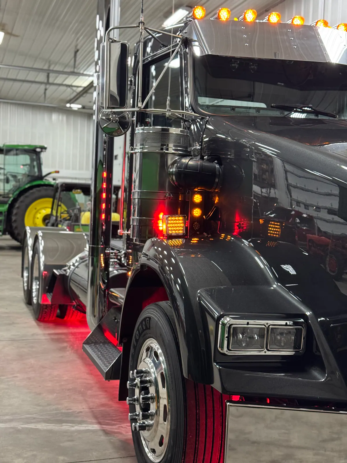 Front quarter of a polished black and chrome semi truck